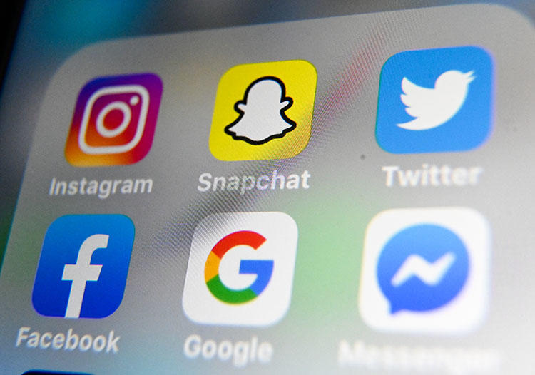 A picture taken on October 1, 2019 in Lille shows the logos of mobile apps Instagram, Snapchat, Twitter, Facebook, Google and Messenger displayed on a tablet. (Photo by DENIS CHARLET / AFP)