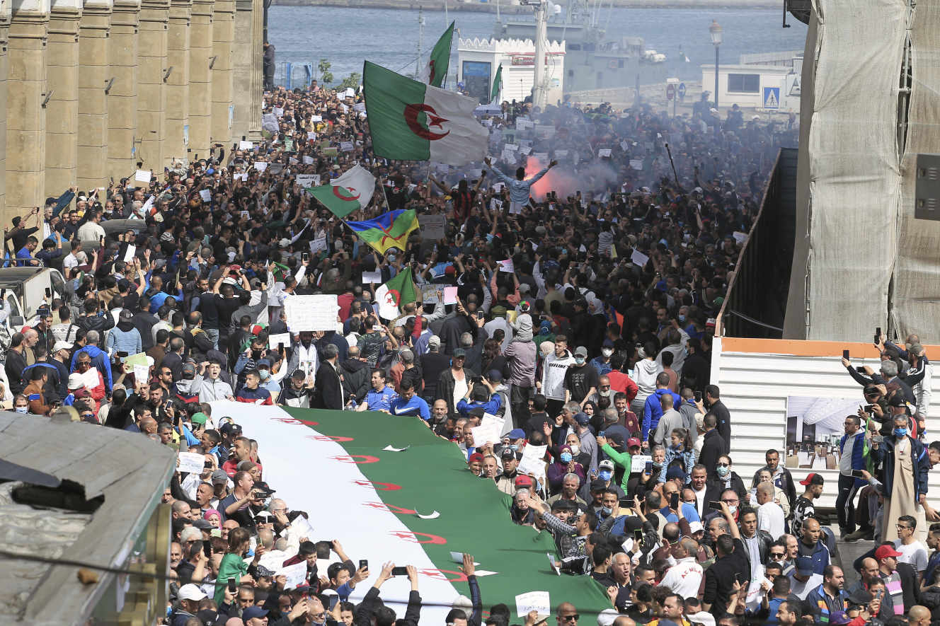 FILE - In this April 2, 2021 file photo, demonstrators invade the streets of Algiers. A crackdown on the pro-democracy Hirak movement, with hundreds arrested around Algeria during last week's 117th Friday march, casts a pall over presidential efforts to give a new face to a nation whose army plays a backseat role in governance. (AP Photo/ Fateh Guidoum, File)