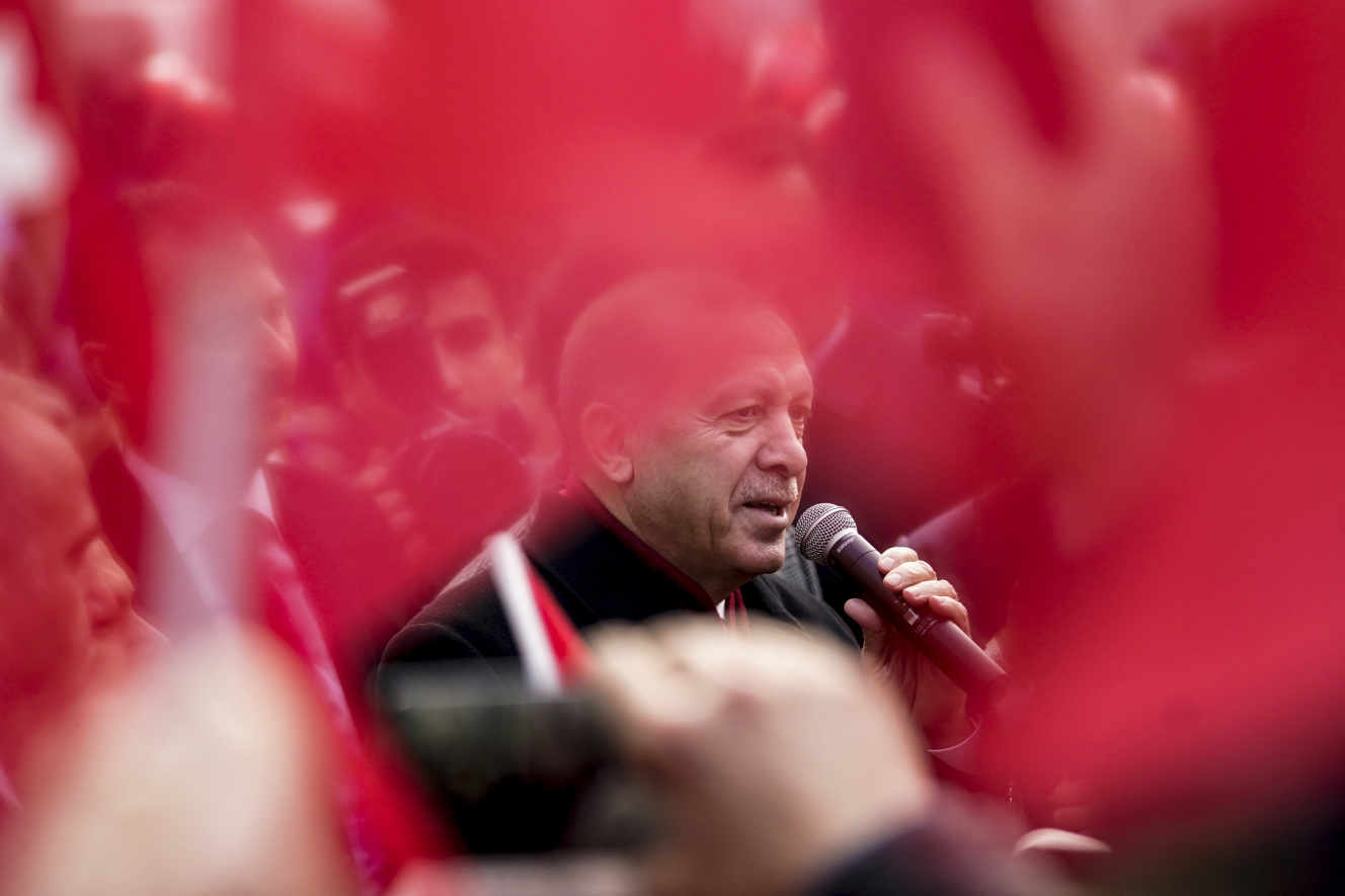 Turkish President Recep Tayyip Erdogan delivers a speech as he arrives for a meeting at Permanent Representation of Turkey to the European Union in Brussels on March 9, 2020. - EU chiefs meet Turkey's President Recep Tayyip Erdogan on March 9, 2020 to warn him not to trigger a renewed migrant crisis on their southeastern border, as member states offered to take in some child refugees. (Photo by Kenzo TRIBOUILLARD / AFP)